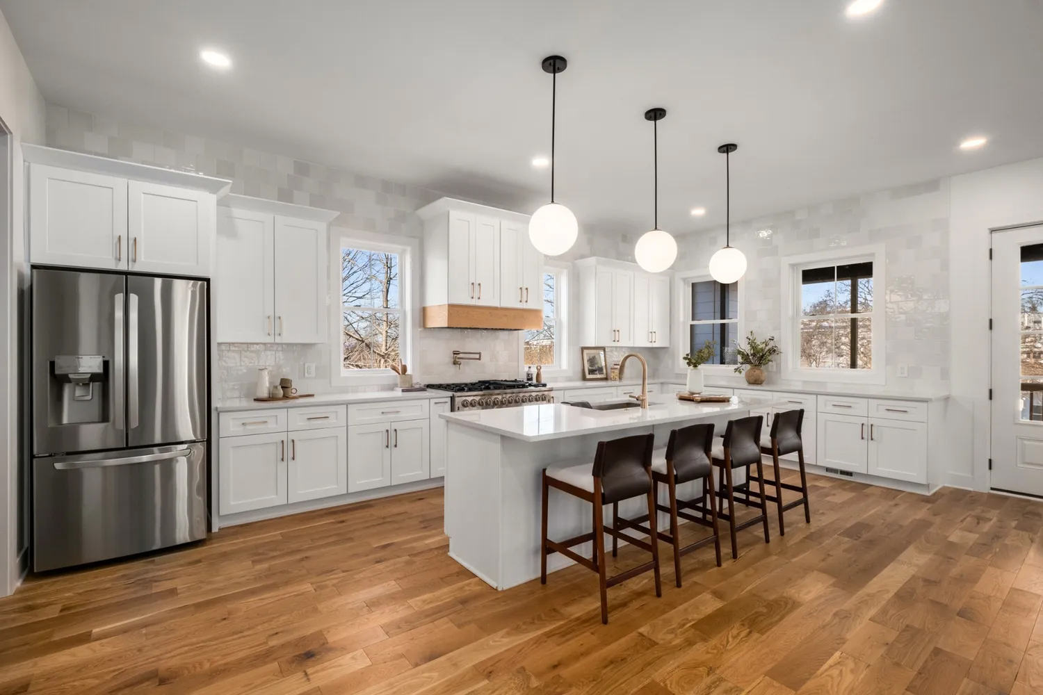 Luxurious White Kitchen with Marble Details and Chic Lighting