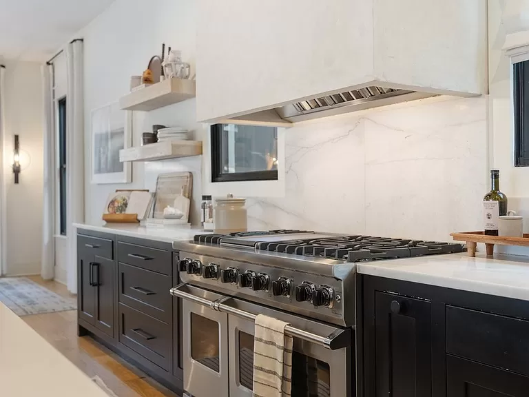 Modern Kitchen with Dark Cabinetry and Marble Accents